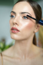 Woman applying mascara with a brush